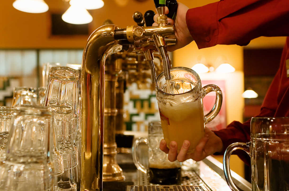 Man is pouring beer into the glass