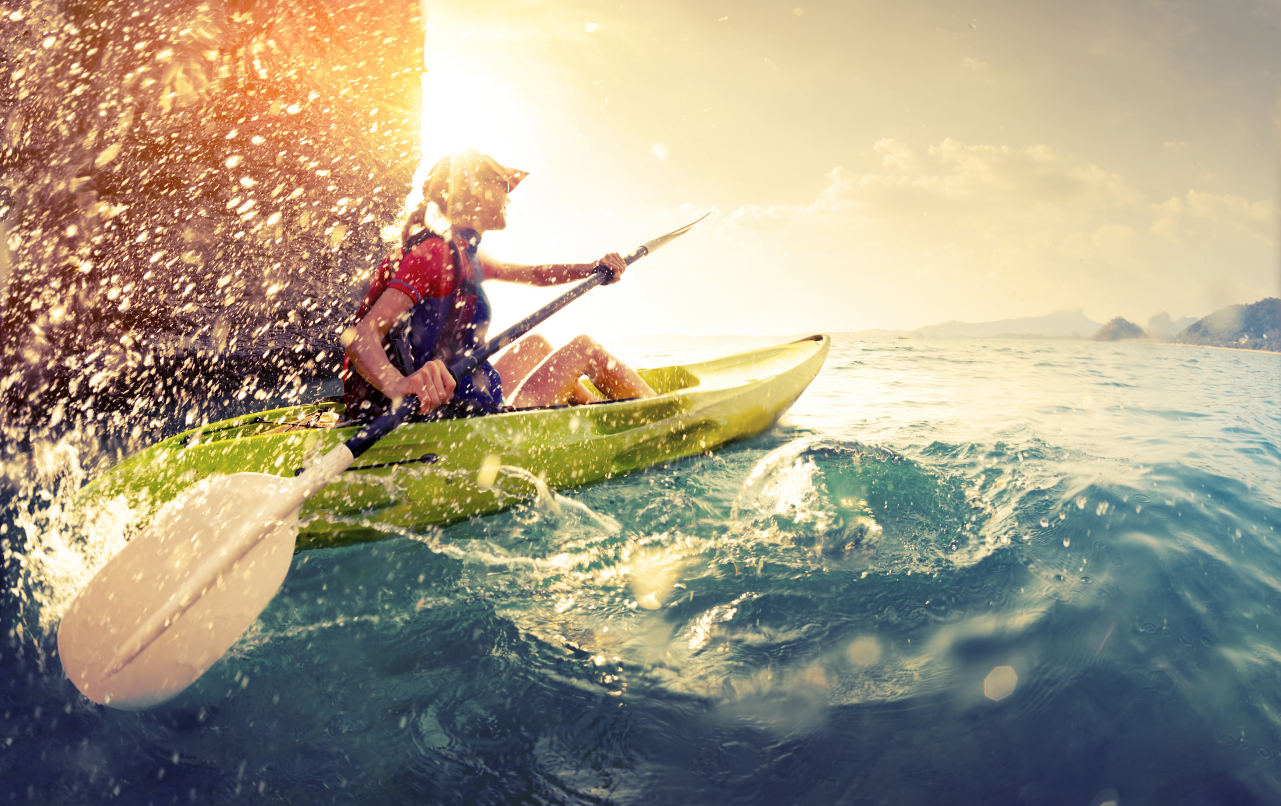 Young lady paddling the kayak