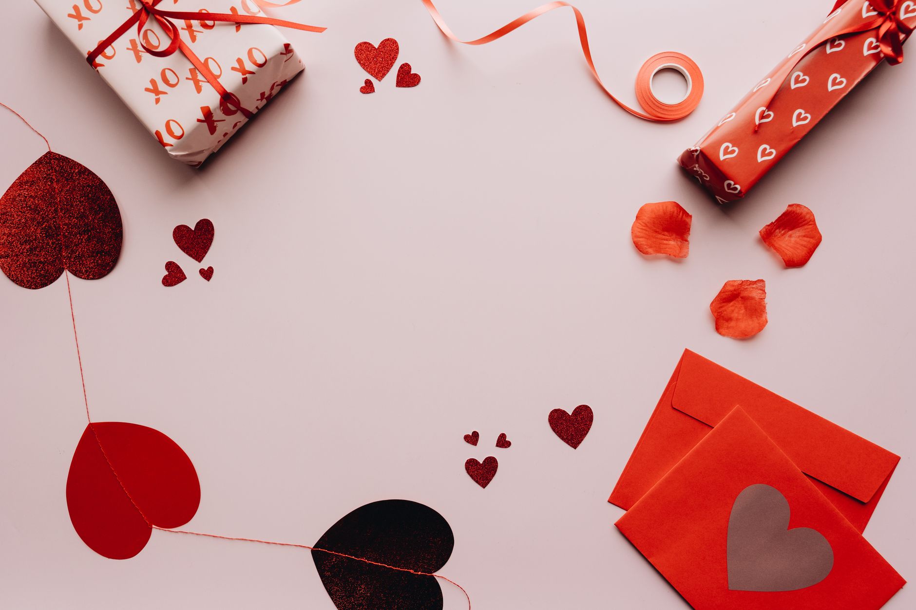 Celebrate love with this romantic Valentine's Day flat lay featuring gifts, envelopes, and heart decorations.