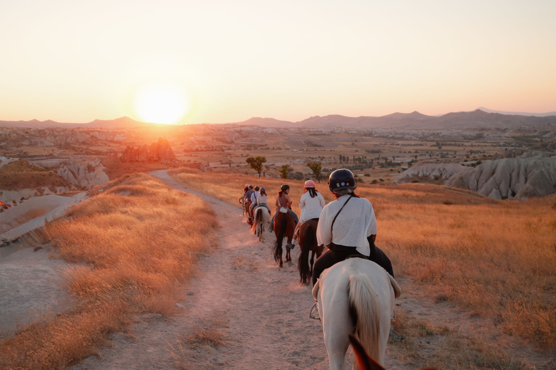 A scenic sunset horseback ride through the unique landscapes of Cappadocia.