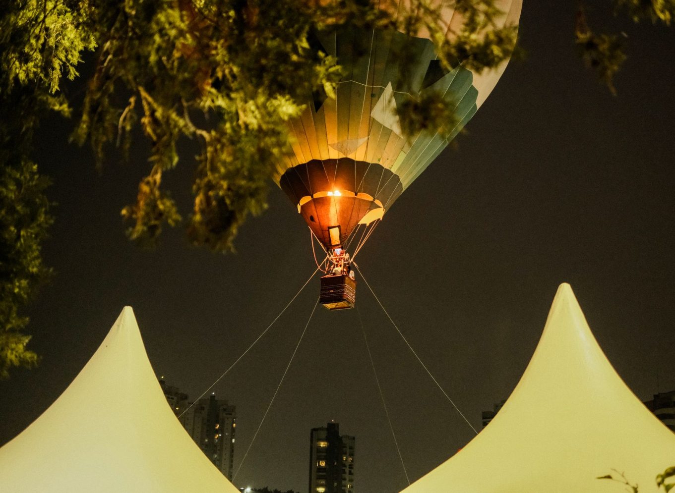 Hot air balloon soaring in the night sky during a festival in São Paulo, Brazil.