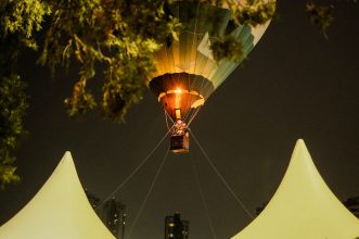 Hot air balloon soaring in the night sky during a festival in São Paulo, Brazil.