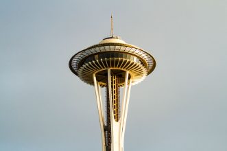 Close-up view of the Space Needle against a clear sky in Seattle.