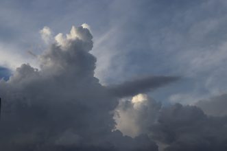 A breathtaking view of towering cumulus clouds against a late afternoon sky.