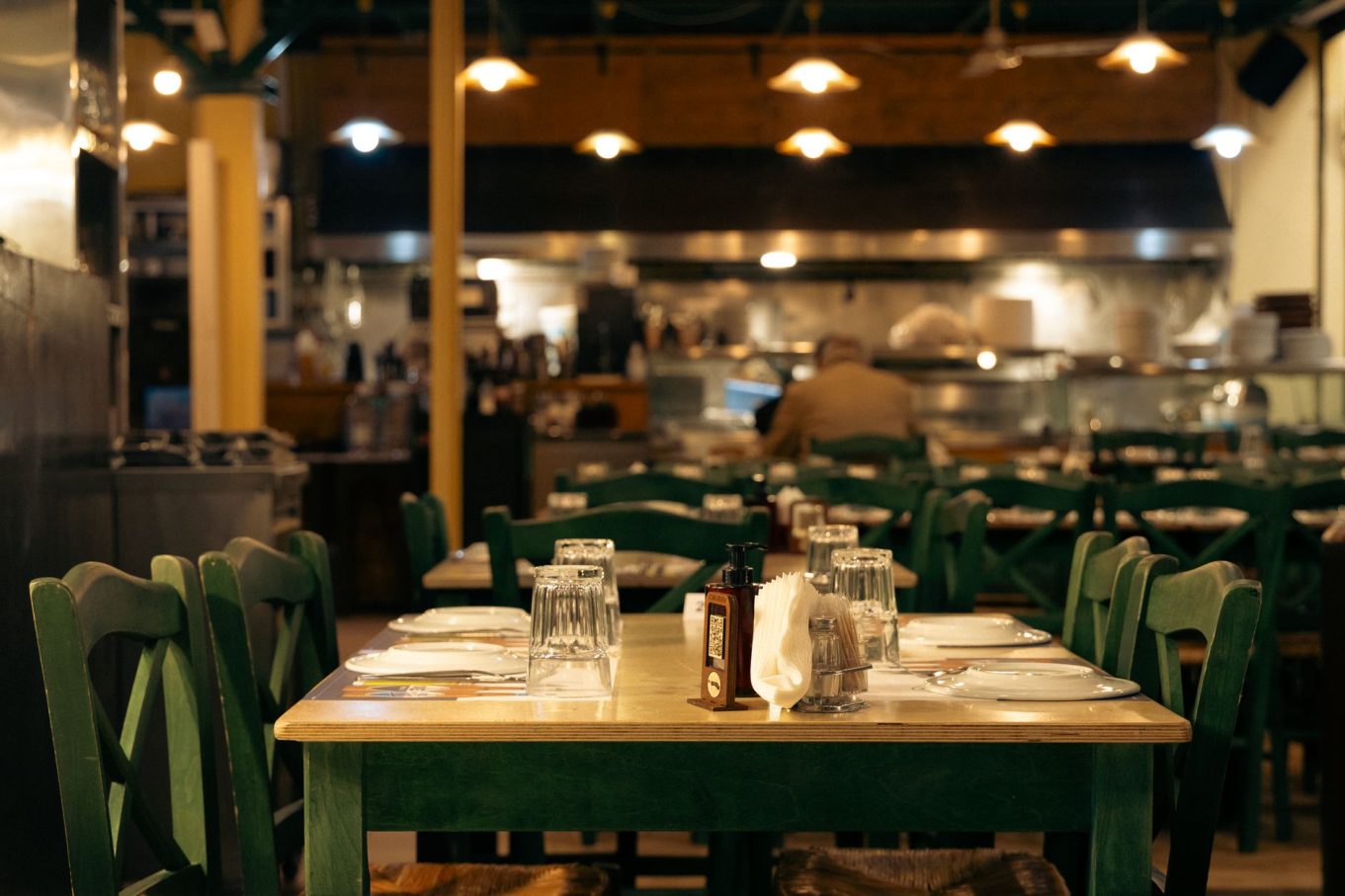 Warm and inviting Greek café interior with set dining tables in Athens, Greece.
