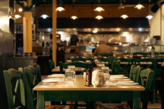Warm and inviting Greek café interior with set dining tables in Athens, Greece.